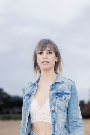 Confident Strides: Stylish Woman in Denim and Lace Exudes Empowerment with Every Determined Stepの写真素材