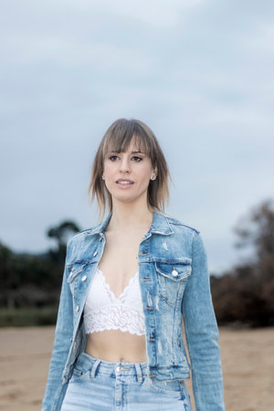 Seaside Elegance: Relaxing Beachfront Stroll in Denim and a Lace Bralette on a Sunny Dayの素材
