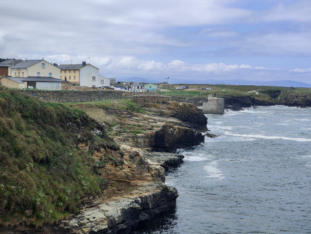 Coastal Village s Charm: Overlooking the Rocky Shoreline and Grey-Roofed Buildingsの写真素材