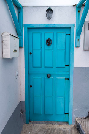 A Portal to the Past: Blue Wooden Door in a White Wallの写真素材