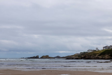 Sky Over a Peaceful Beach with Scattered Rocks and Seaweedの写真素材