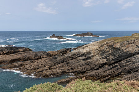rocky coastline with the ocean in the background under a clear blue skyの写真素材