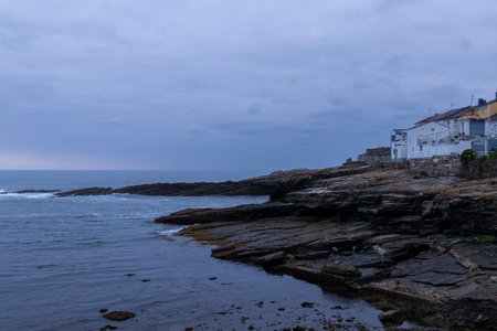 the coast in the town of rinlo in lugo at nightの写真素材