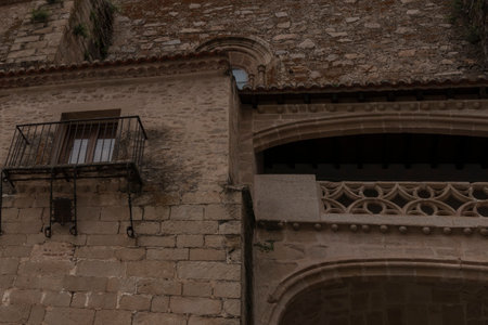 Architectural detail of an old stone building featuring various balconies and building styles from different erasの写真素材
