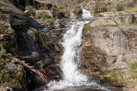 White water cascading down rocks in a natural landscape, creating a picturesque sceneの写真素材