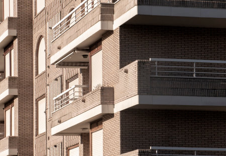 Contemporary brick apartment building featuring multiple balconies