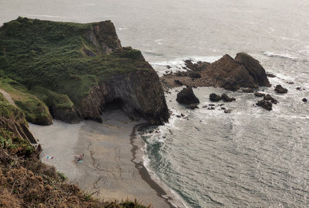 Scenic view of rocky coastline with cliffs and crashing waves