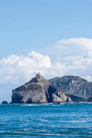 Scenic view of san juan de gaztelugatxe, a beautiful islet on the coast of biscay with a church on top and a winding stairwayの写真素材