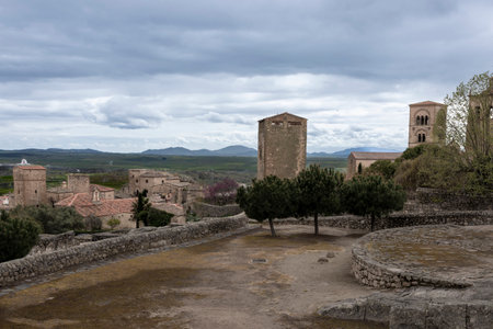 Panoramic view of trujillo castle, its towers and walls, with the extremadura landscape stretching out under a cloudy skyの写真素材