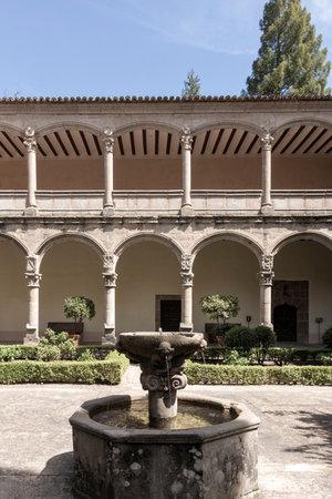 Ornate stone fountain sprinkling water in the serene courtyard of the historic monastery of san lorenzo de el escorial, a unesco world heritage siteの写真素材