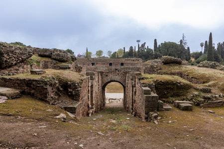 Remains of the ancient mÃ©rida roman amphitheater vomitorium entrance under a cloudy skyの写真素材