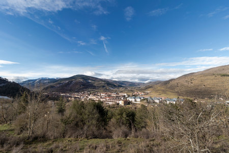Beautiful landscape showcasing a small town nestled amidst the pyrenees mountains, under a vibrant blue skyの写真素材