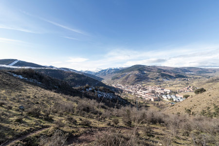 Breathtaking view of a small village nestled in a valley surrounded by the majestic pyrenees mountains on a clear winter dayの写真素材