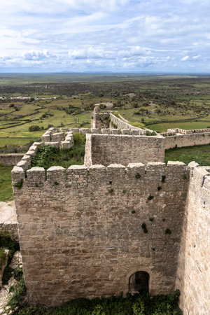 Ruins of castle with stone walls and surrounding fieldsの写真素材