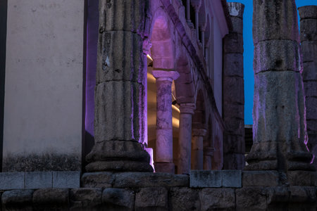 Columns of the temple of diana in merida illuminated with purple light at twilight