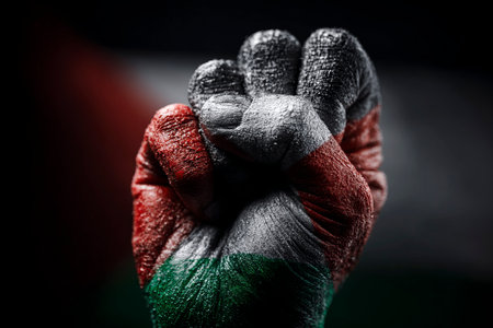 Raised fist showing palestinian flag representing resistance, power, and supportの写真素材