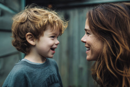 Mother and son smiling and laughing, facing each other with joyの素材