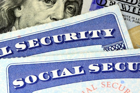 Social security card and US currency one hundred dollar bill Retirement Concept Social Security Benefitsの写真素材
