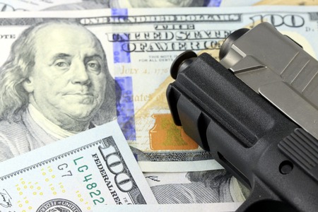 Hand Gun with American Currency - Hundred Dollar Bill Financial Security conceptの写真素材