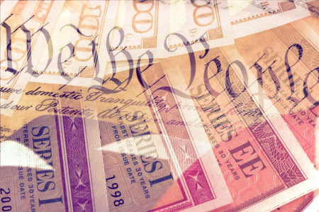 Double exposure US constitution We the People, American flag and treasury savings bond - Finance and government conceptの写真素材