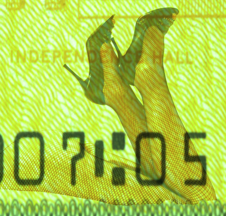 Double exposure female legs and high heels with American dollar backgroundの写真素材