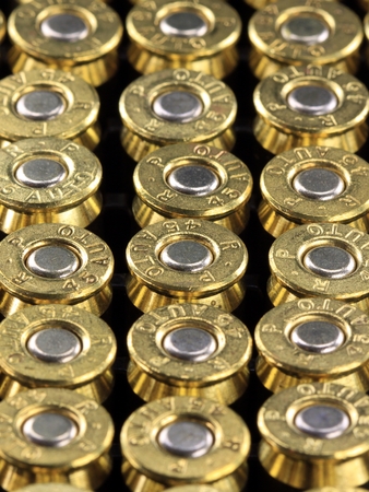 A stack of copper plated bullets with brass slugs