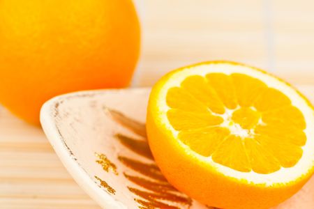 Half orange on the plateの写真素材