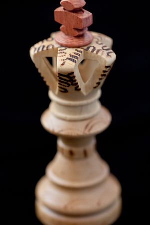 white chess king isolated on a black backgroundの写真素材