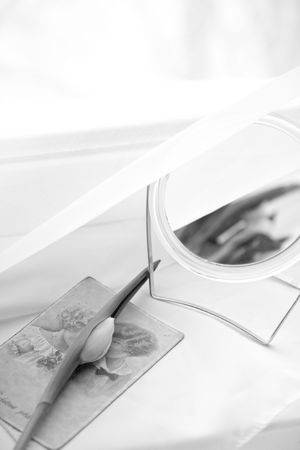 White tulip with mirror near windowの写真素材