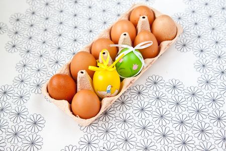 Painted Colorful Easter Eggs and normal eggs in a setの写真素材