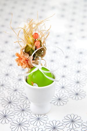 Painted green Easter Egg in a egg-cupの写真素材