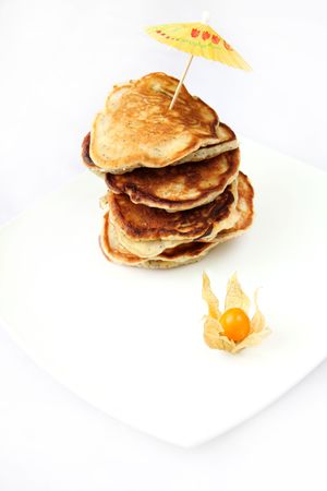 Stack of freshly prepared pancakes on a white backgroundの写真素材