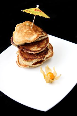 Stack of freshly prepared pancakes on a black backgroundの写真素材