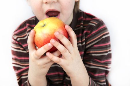 Little boy eating an appleの写真素材