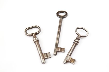 Three isolated old keys on a white backgroundの写真素材
