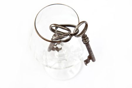 Three old keys in a glassの写真素材