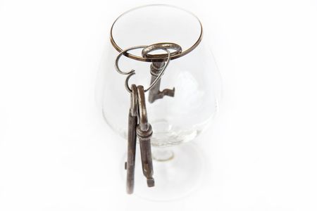 Three old keys in a glassの写真素材