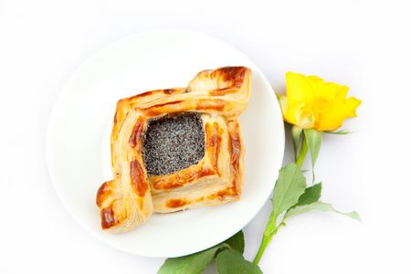 Freshly baked flaky croissant with poppy on a white background の写真素材