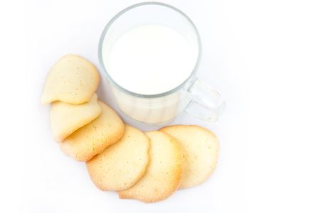 Freshly baked almond cookies with a cap of milkの写真素材