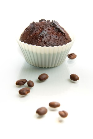 chocolate muffin isolated on white background with coffee beans の写真素材