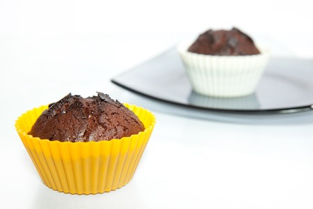tow chocolate muffins isolated on white background の写真素材
