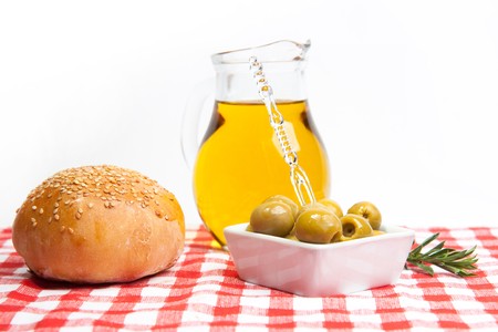 Olive oil with green olives and fresh breadの写真素材