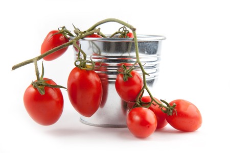Branch of fresh cherry tomatoes on the white backgroundの写真素材