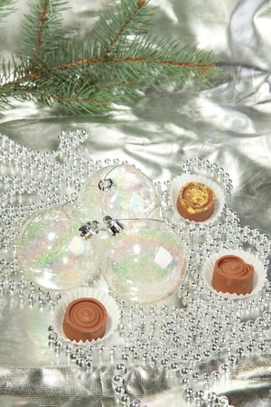 Transparent christmas balls with a homemade chocolate on a silverの写真素材