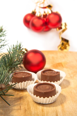 Red christmas balls with a homemade chocolate and christmas treeの写真素材