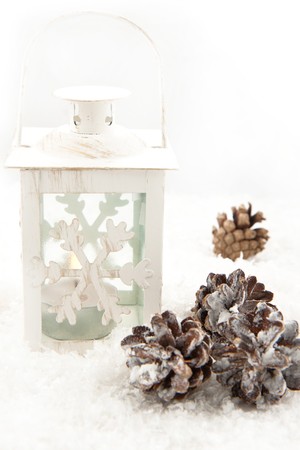 White christmas lightning lantern and forest cones on a snowの写真素材