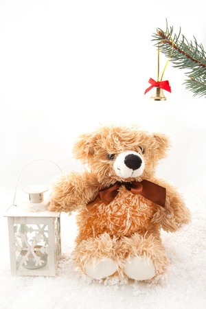 Teddy-bear with christmas lantern on the white backgroundの写真素材