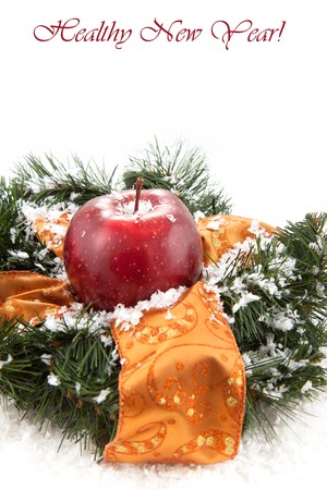 Christmas wreaths with fresh red apple on the white backgroundの写真素材