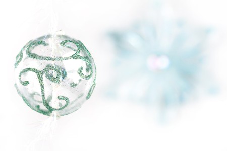 Transparent christmas ball with bluring snowflakeの写真素材