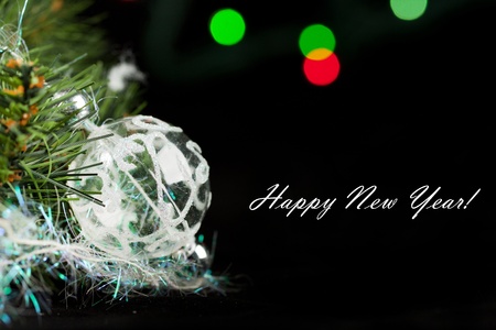 Transparent christmas ball with a christmas tree on the black backgroundの写真素材